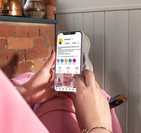 Tamara looking at the Dot and Stripe website on her mobile phone